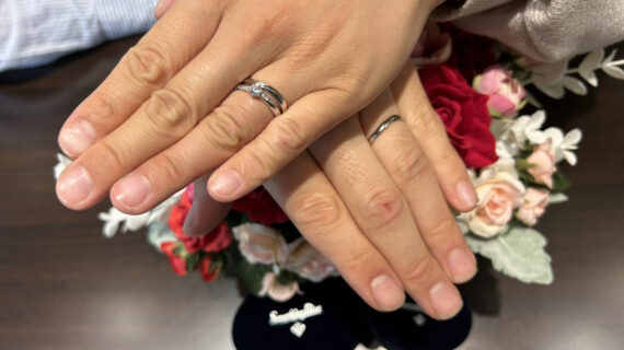サムシングブルーの婚約指輪と結婚指輪をつけたカップル