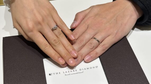 ラザールダイヤモンドの婚約指輪とご結婚指輪を着けたカップルの手元