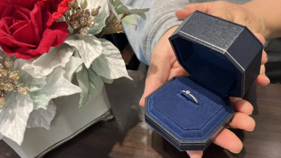 ロイヤル・アッシャーの婚約指輪のケースを持つ男性