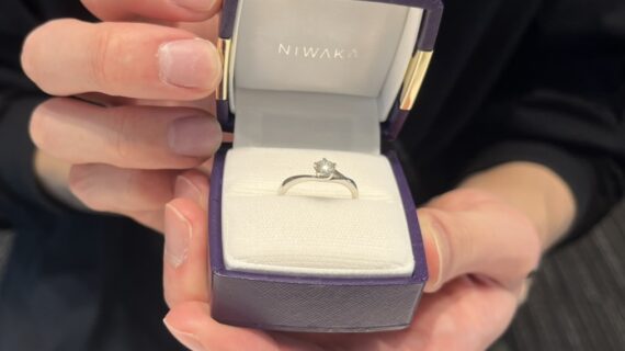 NIWAKA(ニワカ)の婚約指輪「初桜」を手に持った男性の手元