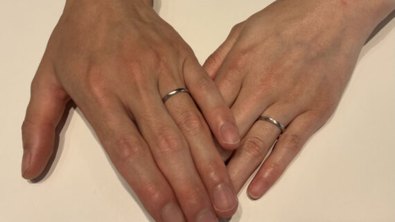 ロイヤル・アッシャーの結婚指輪を着けた男女の手元