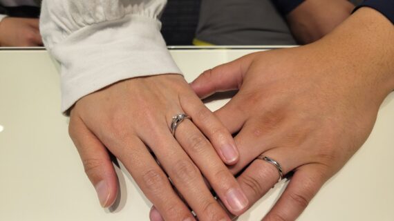ニワカの婚約指輪と結婚指輪を着けたカップルの手元